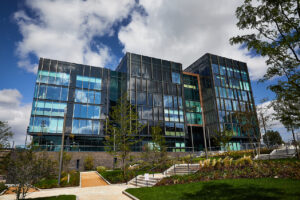 A shot of the Quarry Hill Campus building and park on a summer day