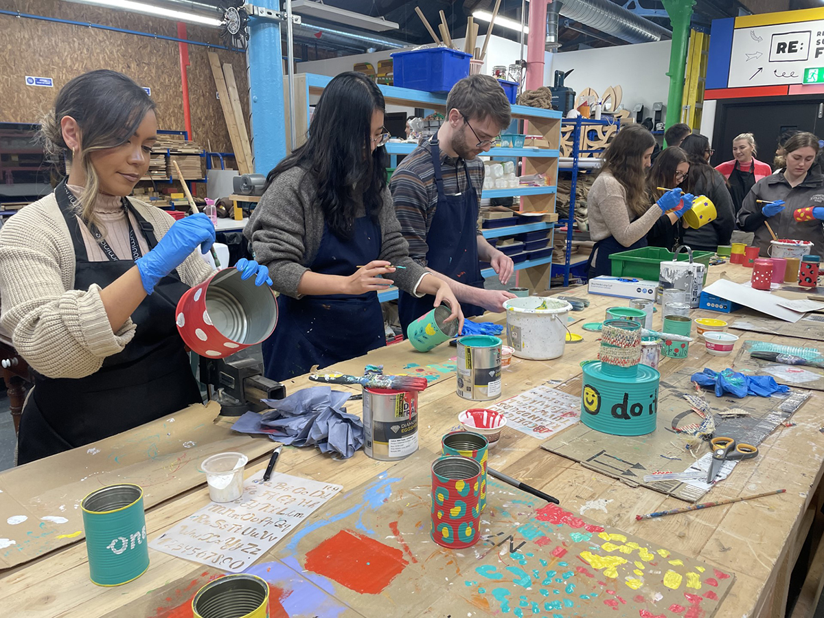 Luminate Marketing staffs having craft workshop in Mabgate Campus painting cans and tin plant pots